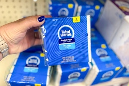 person holding a package of tissue pocket packs