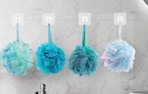 colorful bath loofahs hooked on a wall