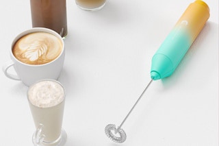 milk frother next to coffee drinks