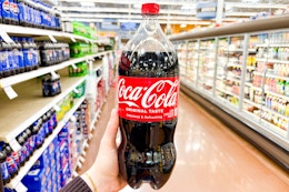 hand holding a bottle of coca cola