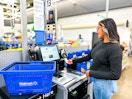 a woman checking out at a walmart self checkout 