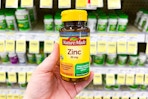 hand holding nature made zinc supplements in walgreens