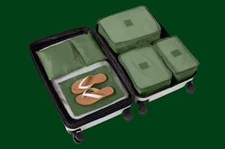 a suitcase with green packing cubes 