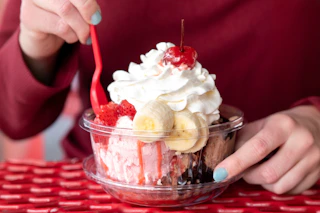 someone eating a banana split from brusters