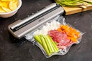 Nesco Vacuum Sealer Machine (lifestyle image) of it being used to seal produce