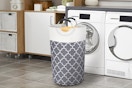 grey laundry bag near washer and dryer