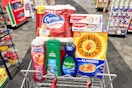 charmin toilet paper, colgate toothpaste, palmolive dish soap, honey bunches of oats cereal, softsoap and irish spring in a cart