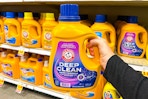hand holding a bottle of arm hammer deep clean detergent
