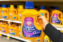 hand holding a bottle of arm hammer deep clean detergent