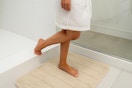 a woman using a bath mat