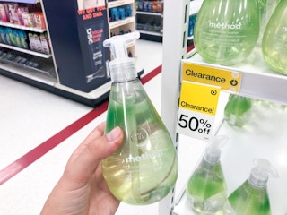 hand holding bottle of Method soap in front of clearance tag