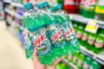 hand holding up a mountain dew 6-pack