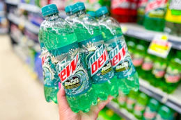 hand holding up a mountain dew 6-pack