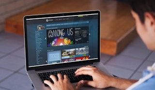 boy looks at steam website on his laptop