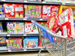 two boxes of advent calendars in walmart cart in front of advents on shelves