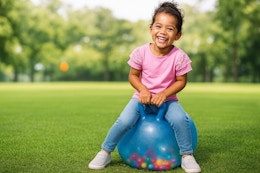 Lifestyle image created by ChatGPT of a girl using the Play Day Bouncer Toy to play outdoors