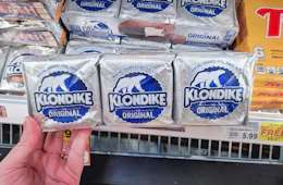 hand holding a pack of klondike bars