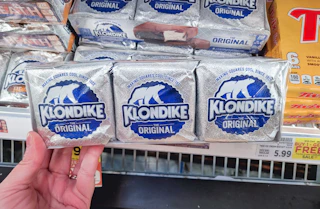 hand holding a pack of klondike bars