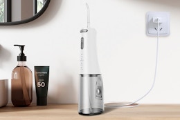 a water flosser charging on a wooden table