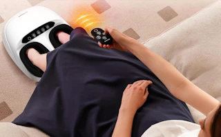 a person sitting with their feet in a foot massager