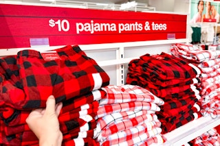 hand grabbing pajama pants off a target shelf