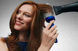 a woman using a bio ionic brush