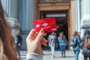 someone holding their bank of america card in front of a museum