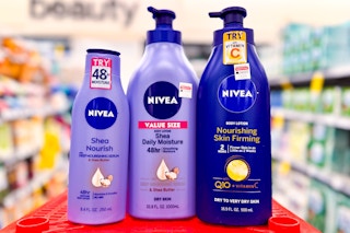 three nivea body lotions on a red surface in a store aisle