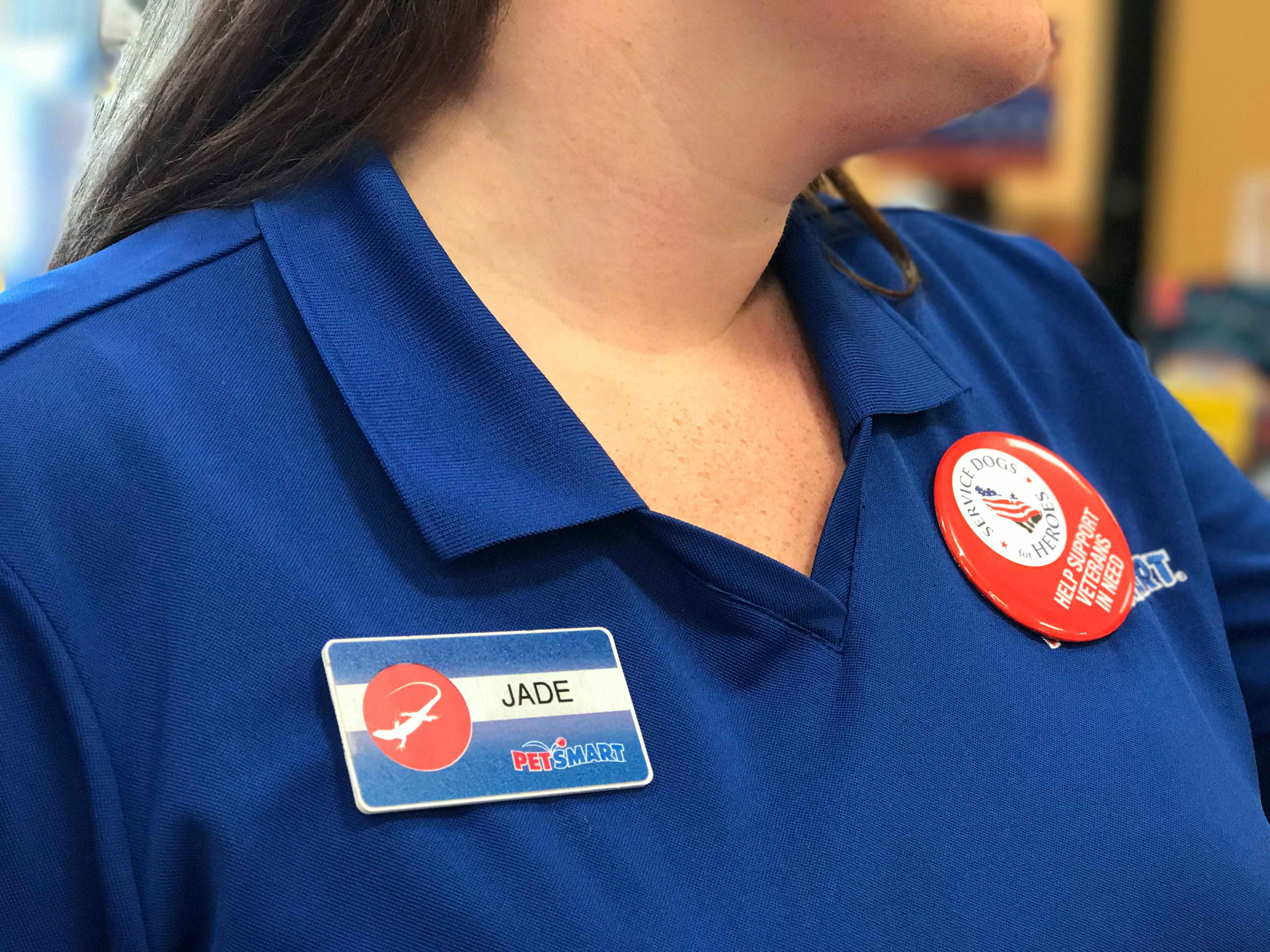 A close-up of a PetSmart employee, showing her name tag that reads, "Jade".