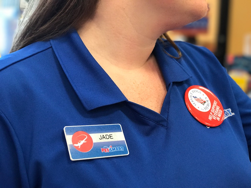 A close-up of a PetSmart employee, showing her name tag that reads, "Jade".