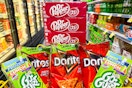 cases of dr pepper soda, doritos, and gogurt in a cart