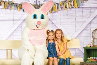 two kids posing for a photo with the easter bunny at cabela's