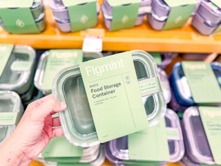 hand holding figmint food storage container in target aisle