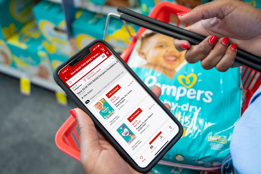 Pampers coupons on the CVS app with a basket holding two packs of pampers diapers.