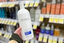 a hand holding a bottle of conditioner