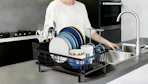 a drying dish rack on a kitchen counter with dishes inside