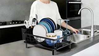a drying dish rack on a kitchen counter with dishes inside