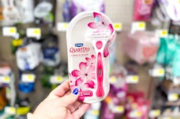 hand holding up schick quattro razors