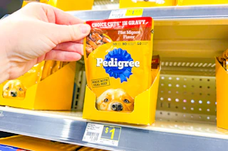 hand grabbing a pedigree wet dog food pouch