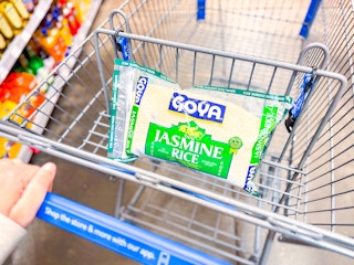 hand pushing cart with a bag of goya jasmine rice