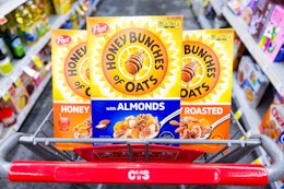 3 boxes of honey bunches of oats cereal in a cart