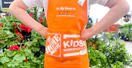 young child posing outside after working on a home depot kids workshop craft