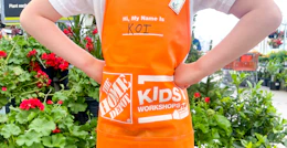 young child posing outside after working on a home depot kids workshop craft