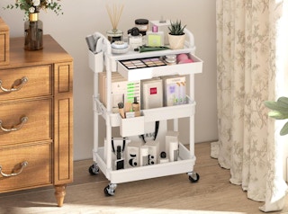 a rolling cart with makeup in a room