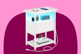 End table with a fabric drawer that opens on the narrow end, plus a charging station with a cord and an LED shelf light.