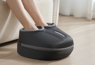 person using the foot massager