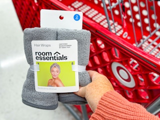 hand holding a room essentials hair wrap set in front of a target cart