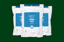 amazon basics cotton balls on a green background