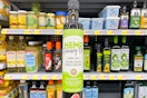 Manitoba Harvest Hemp Culinary Oil held up in front of other cooking oils at Walmart