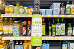 Manitoba Harvest Hemp Culinary Oil held up in front of other cooking oils at Walmart